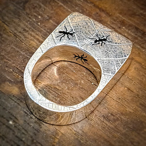 Ring with leaf imprint and ants close up